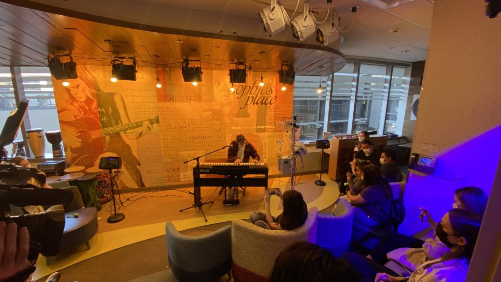 Teen pianist plays in dedicated music therapy space at children's hospital.