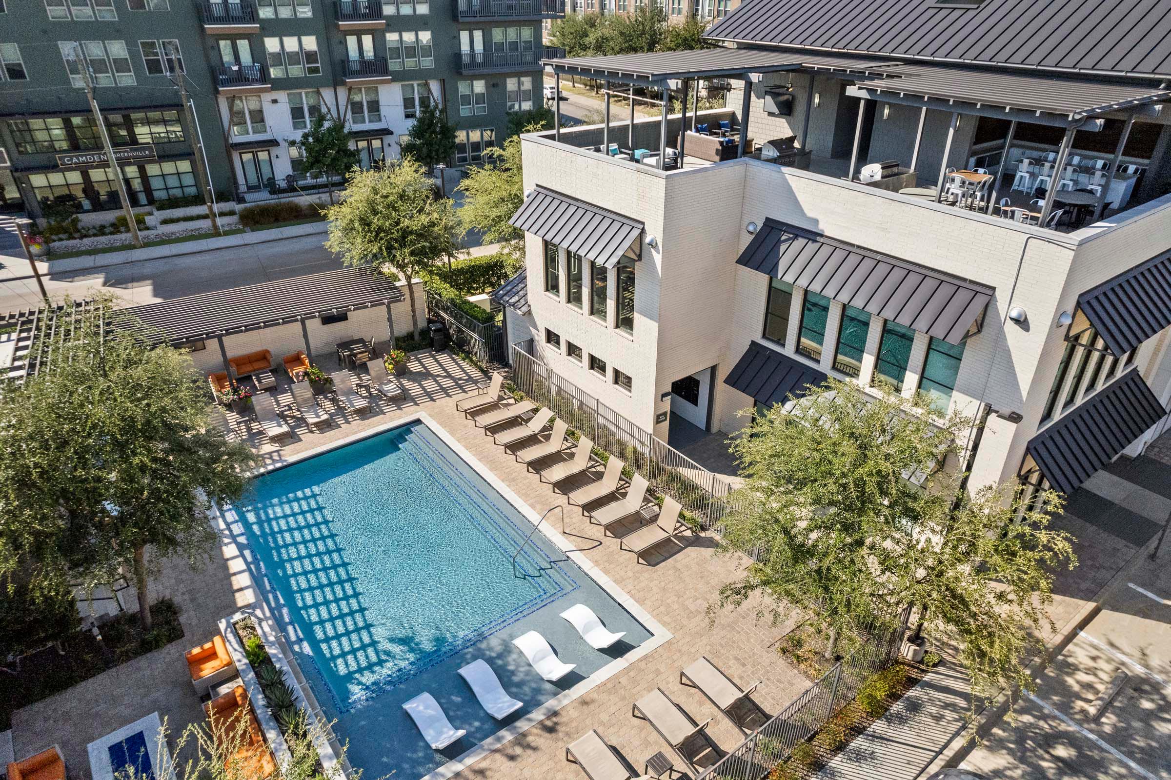 Aerial view of Villas pool and amenity building with rooftop lounge at Camden Greenville