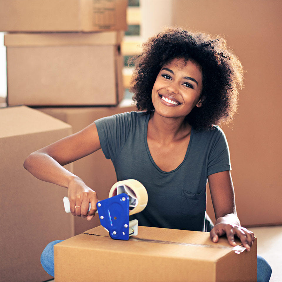 Woman taping a moving box