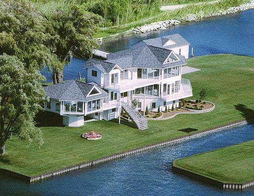 This luxurious, one-of-a-kind, custom-designed contemporary lake house built on Lake St. Clair in Michigan, features two elevated living levels with extraordinary panoramic lake views.