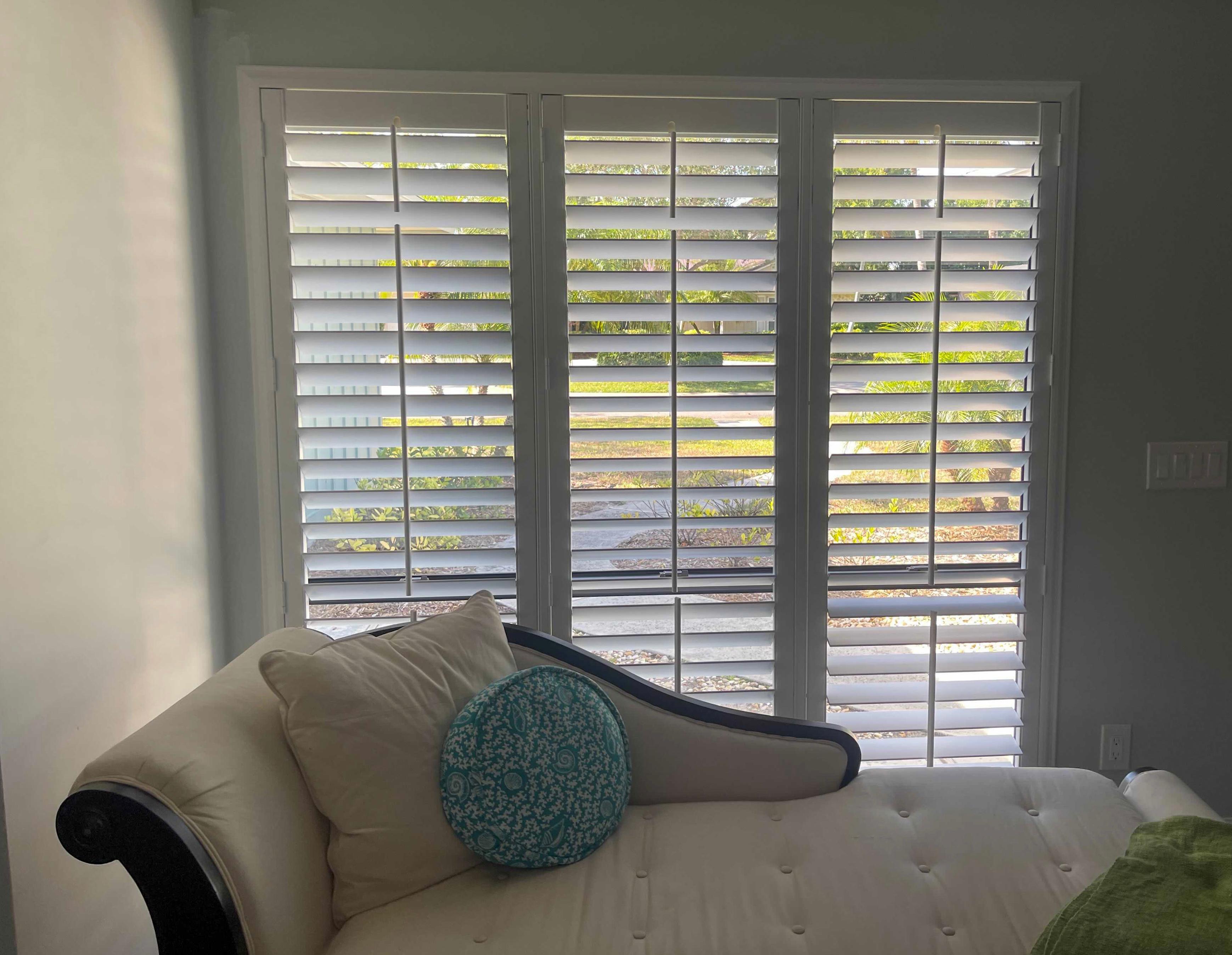 What a lovely place to lounge! Plantation shutters allow for easy light control, plus they're perfect for sneaking a glimpse of some Florida scenery.