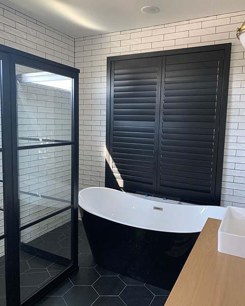 These dark shutters added a stunning yet functional design element to this spa bath.