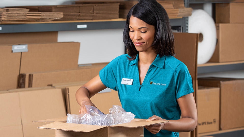 Associate packing an item to ship