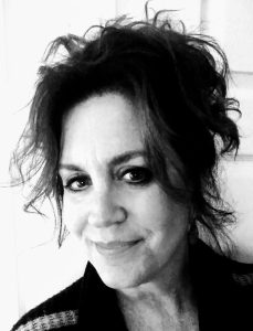 Black and white headshot of woman with hair up