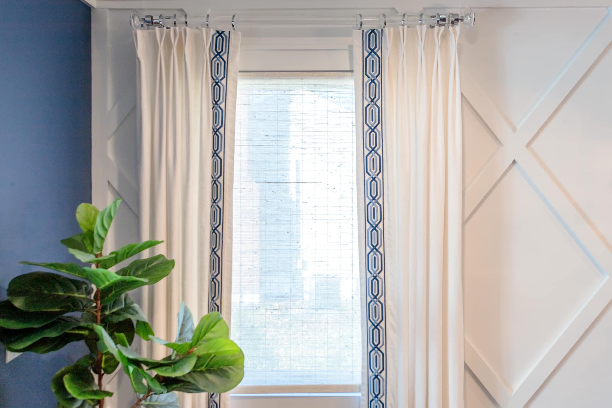 We love this simple white linen drape with navy tape & you can never go wrong with acrylic hardware.