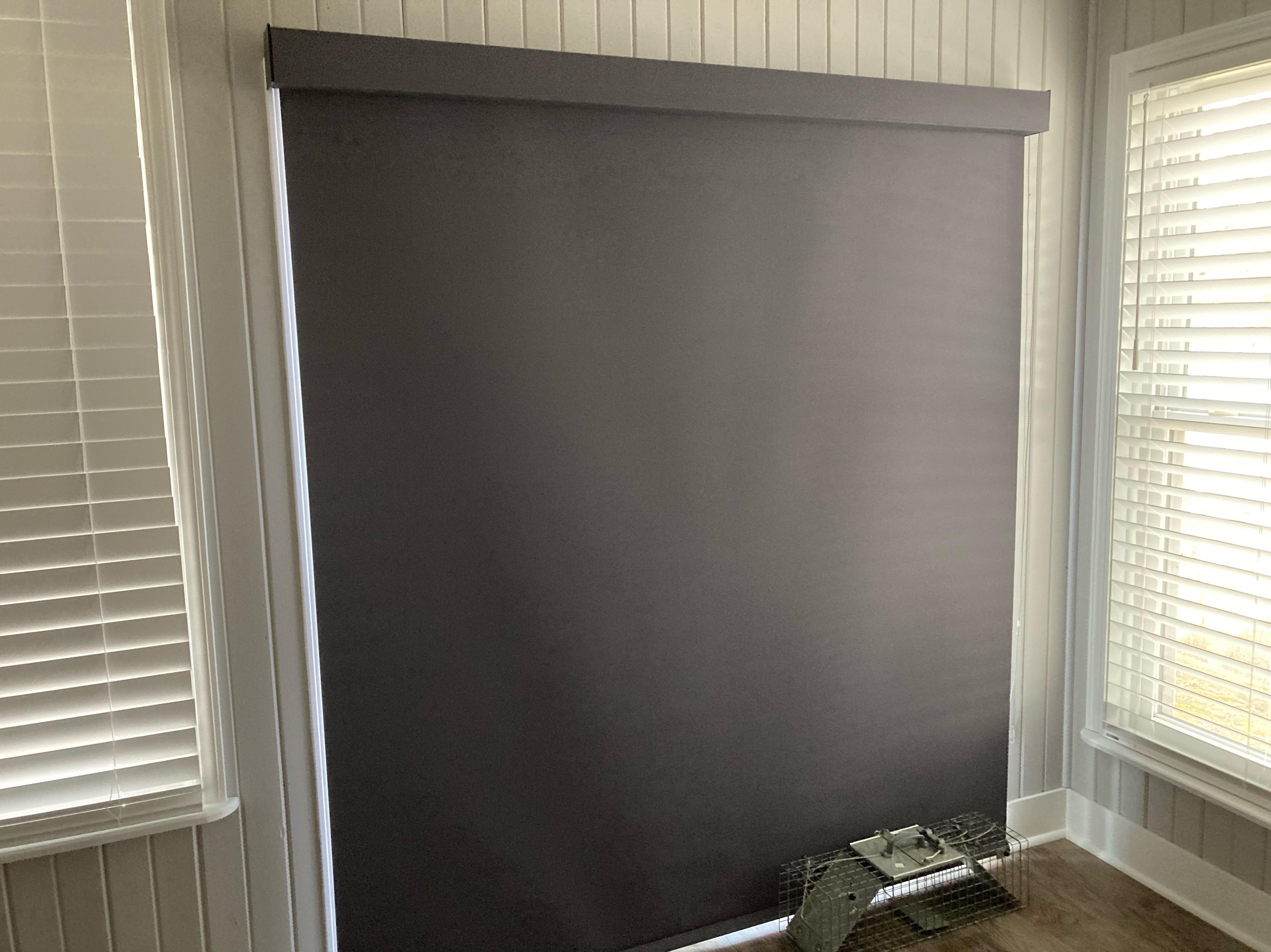 Room darkening roller shade