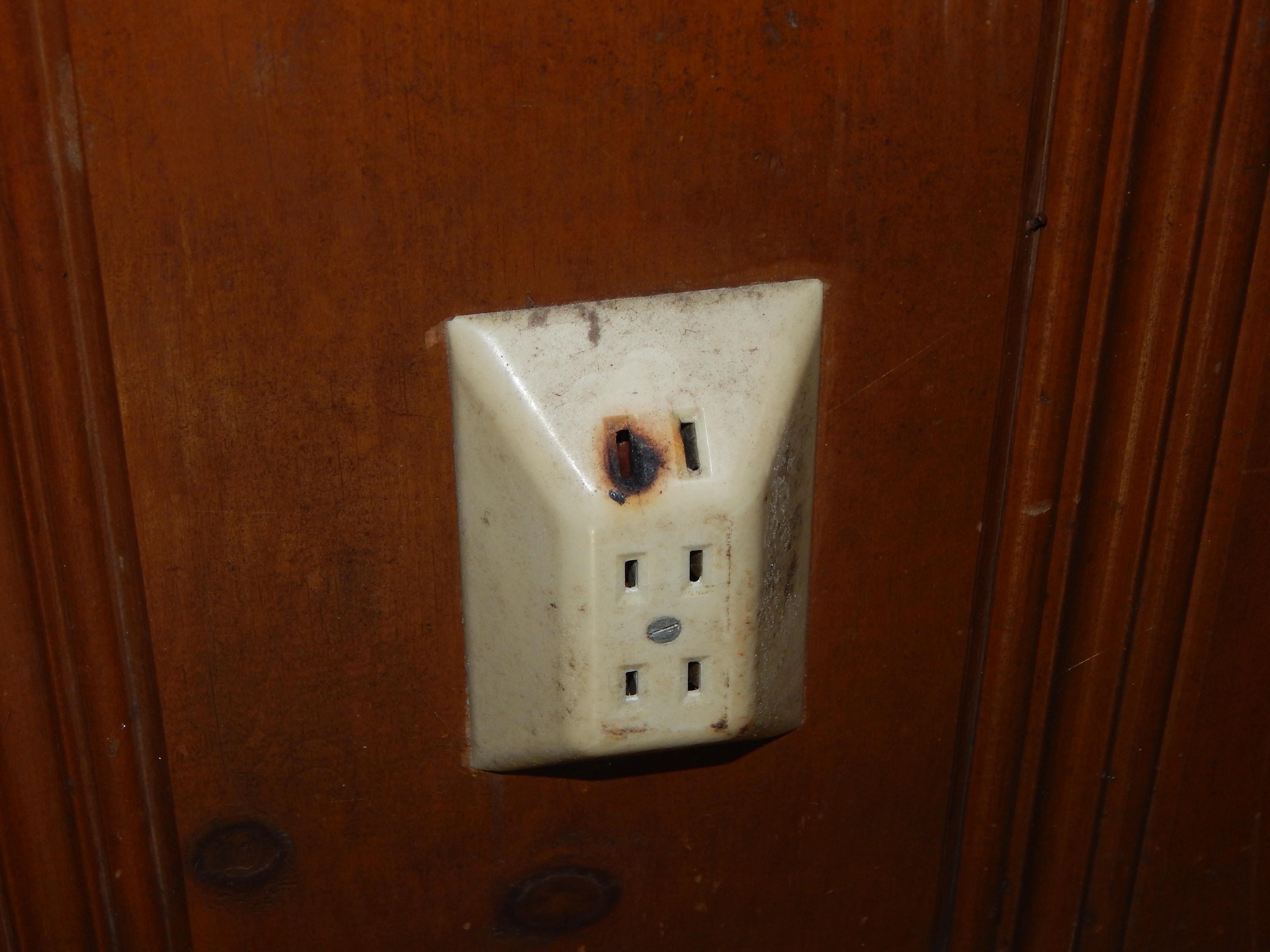 This receptacle shows signs of previous arcing which raises a major safety concern. 