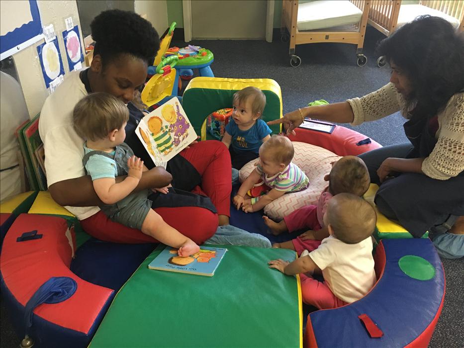 Our infant friends enjoying some circle time with Ms. Ashley and Ms. Manu.