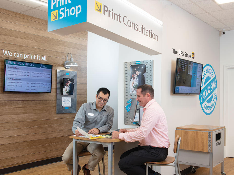 Customer sitting during print consultation at The UPS Store