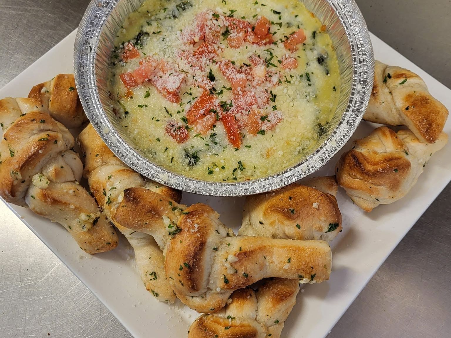 Baked Spinach And Artichoke Dip With Garlic Knots