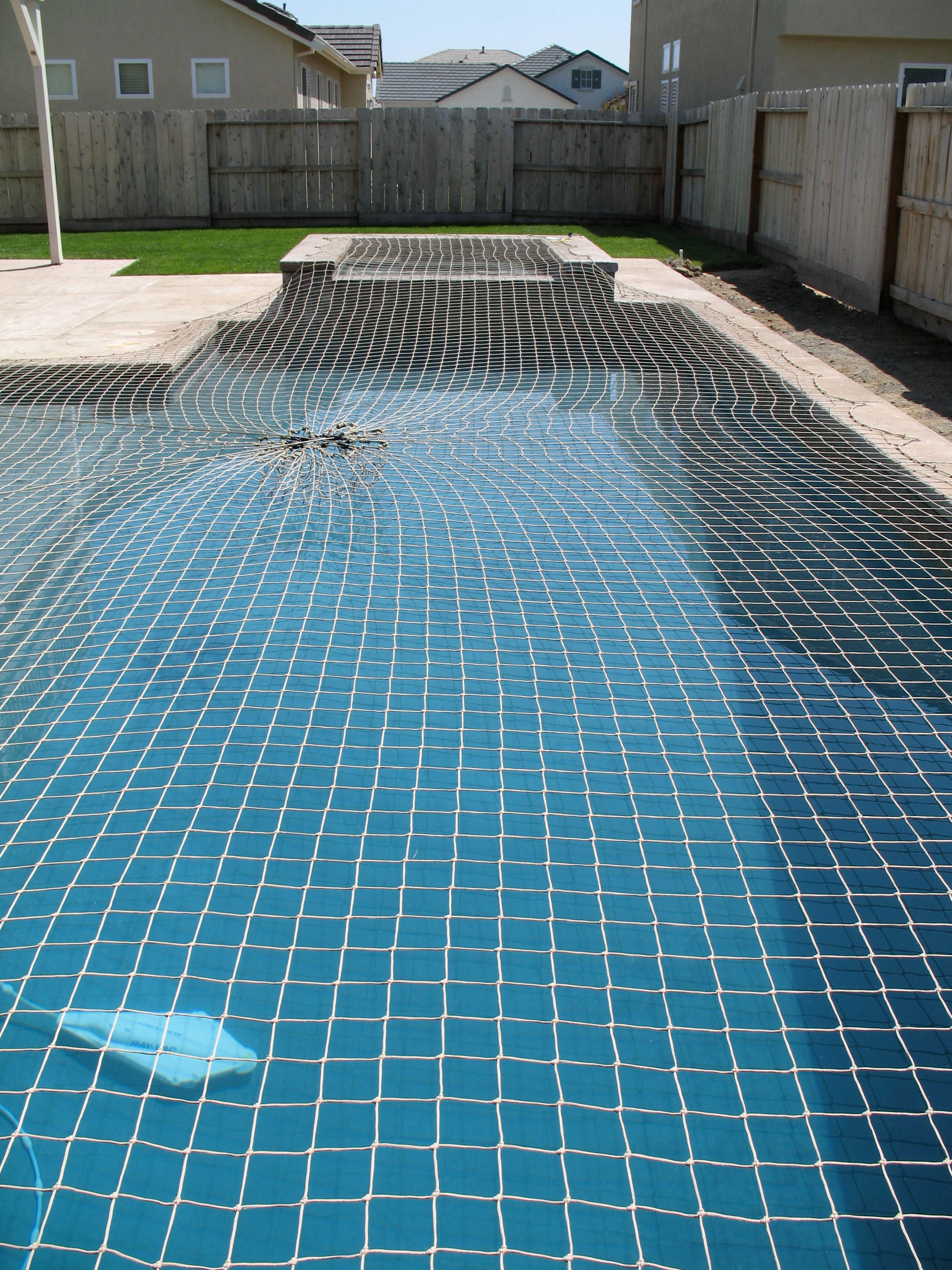 A flush Katchakid pool safety net in desert sand color.