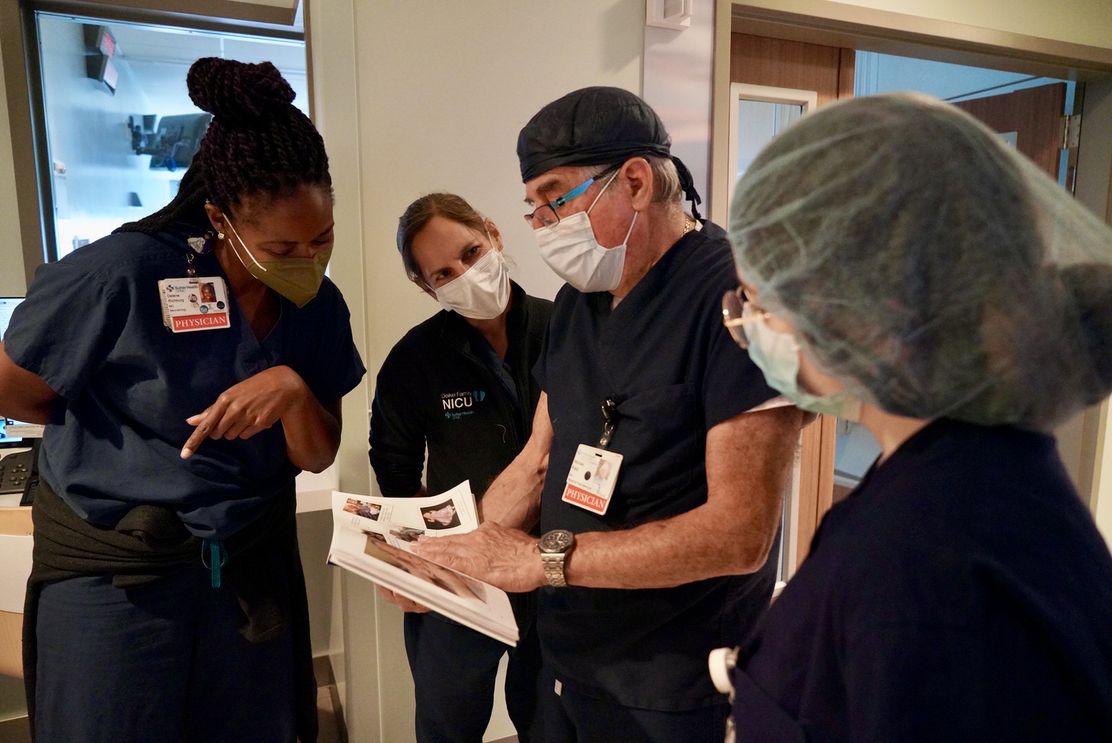 A crowd of doctors and nurses wearing scrubs