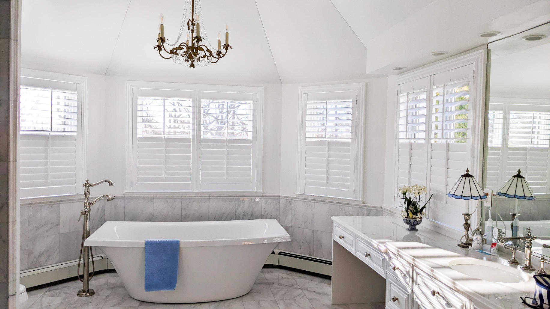 Shutters in master bathroom in French Country inspired home in Colts Neck, NJ