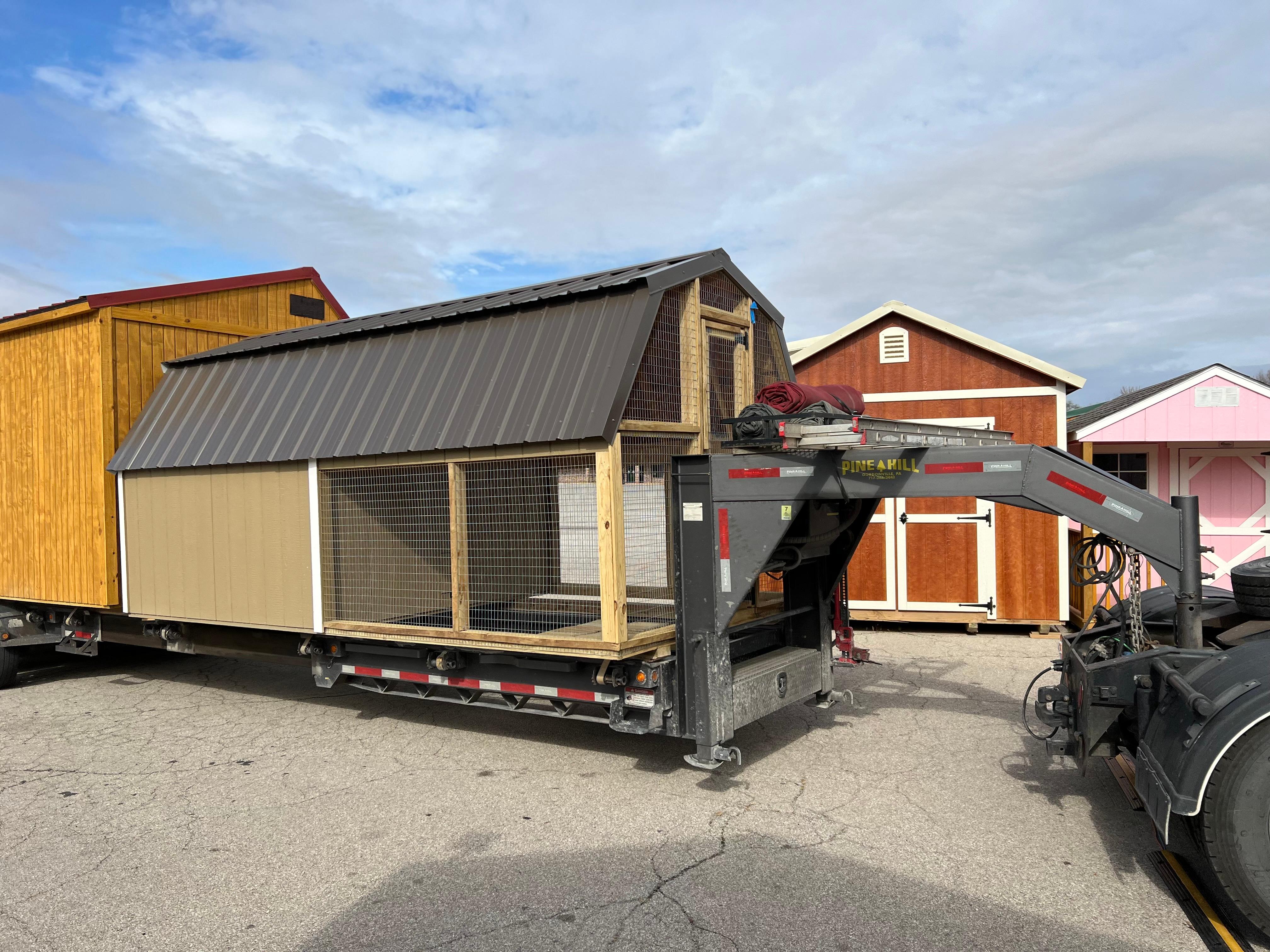 Prebuilt portable chicken coop with nesting boxes.