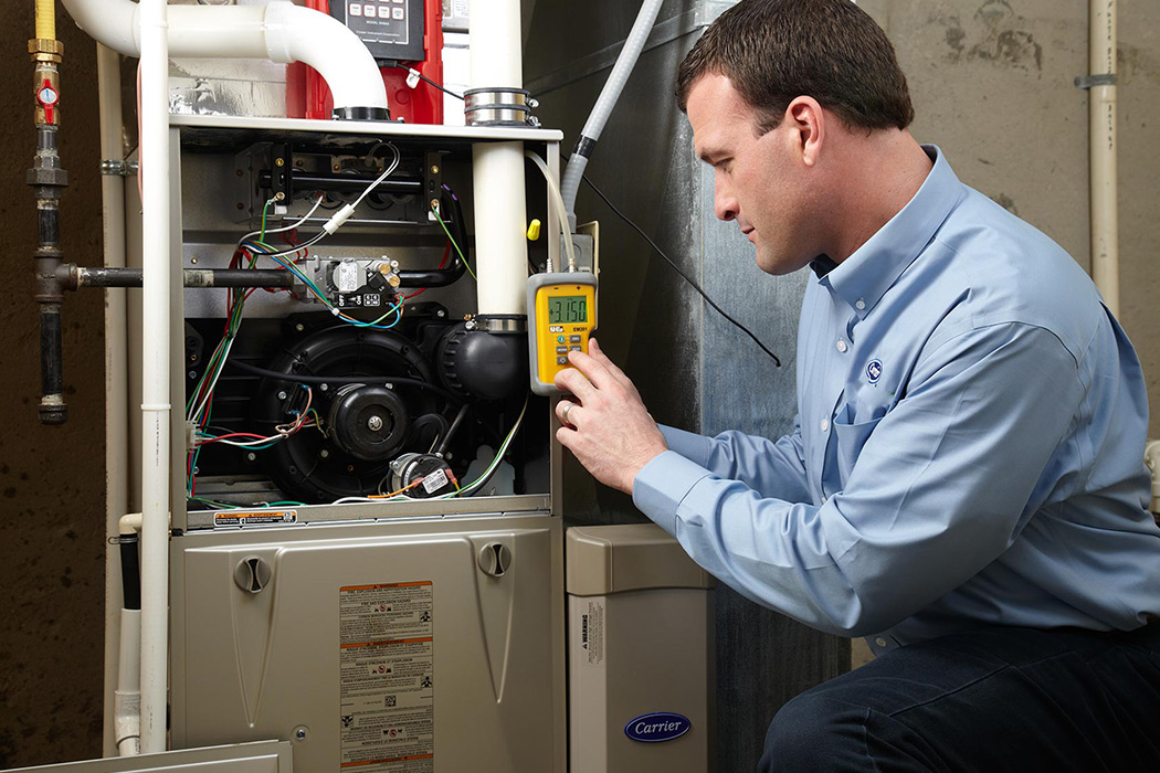 A Carrier dealer discusses air conditioner repair and service with a homeowner