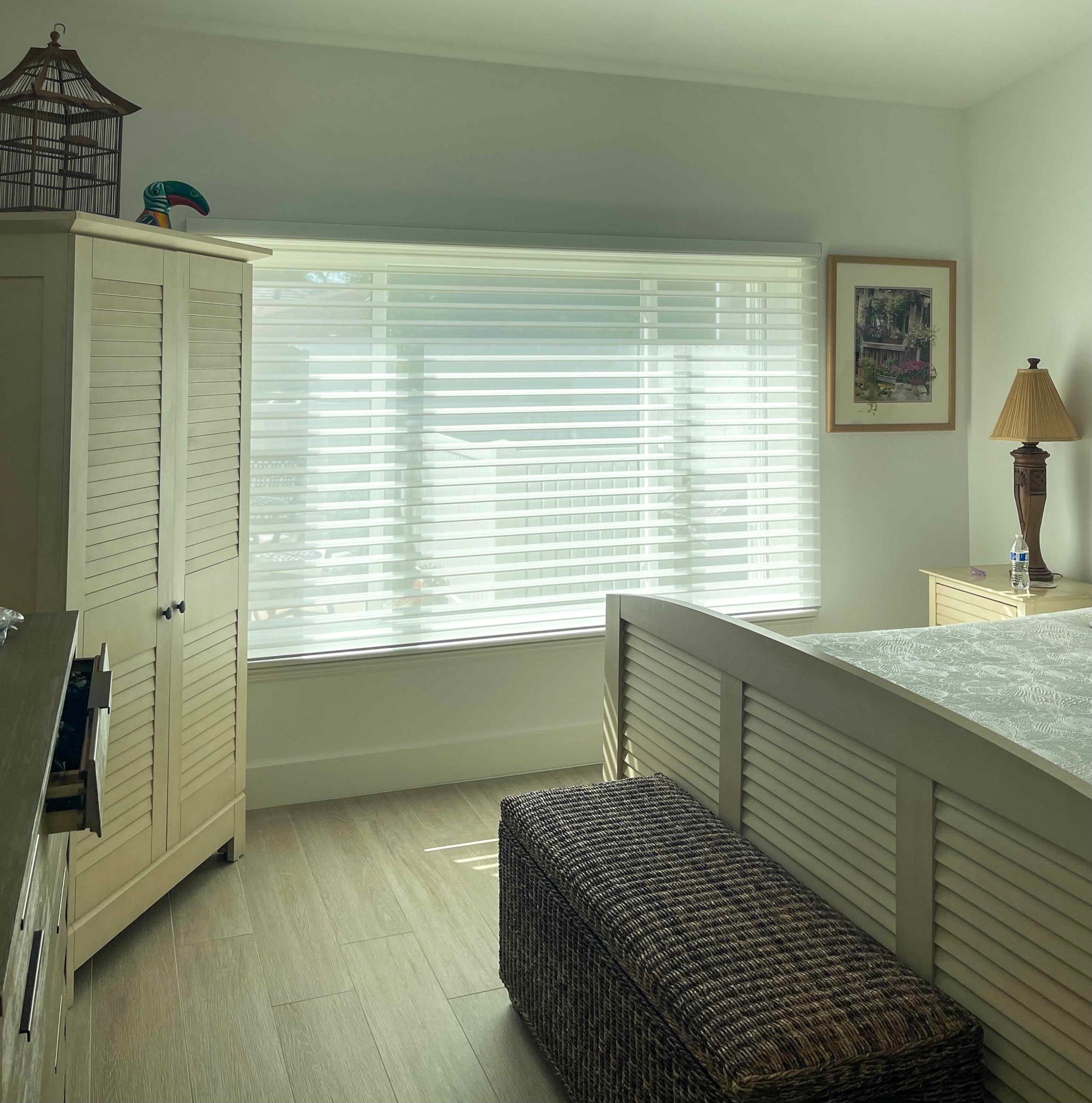 These sheer window shadings create an elevated yet cozy look in this Cocoa bedroom.