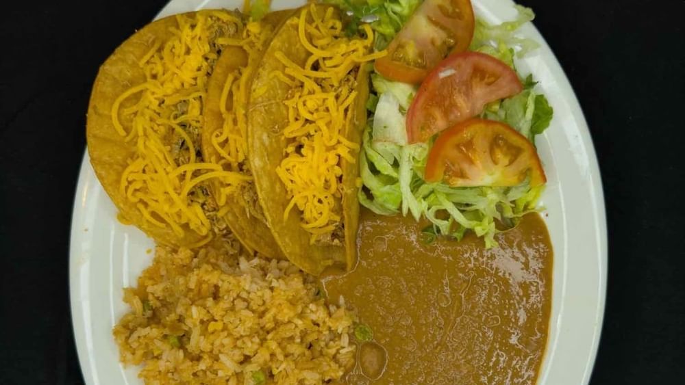 35. 3 Crispy Beef Tacos, Spanish Rice, Refried Beans, and Salad