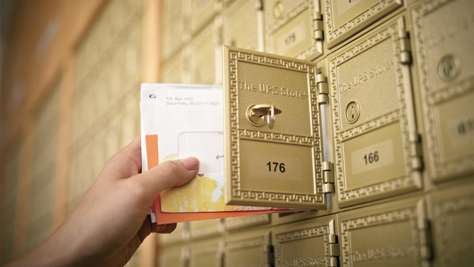 Hand grabbing mail from The UPS Store mailbox