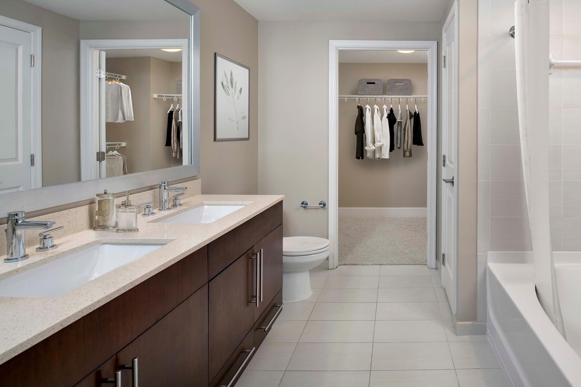 Warm modern style bathroom and large walk-in closet