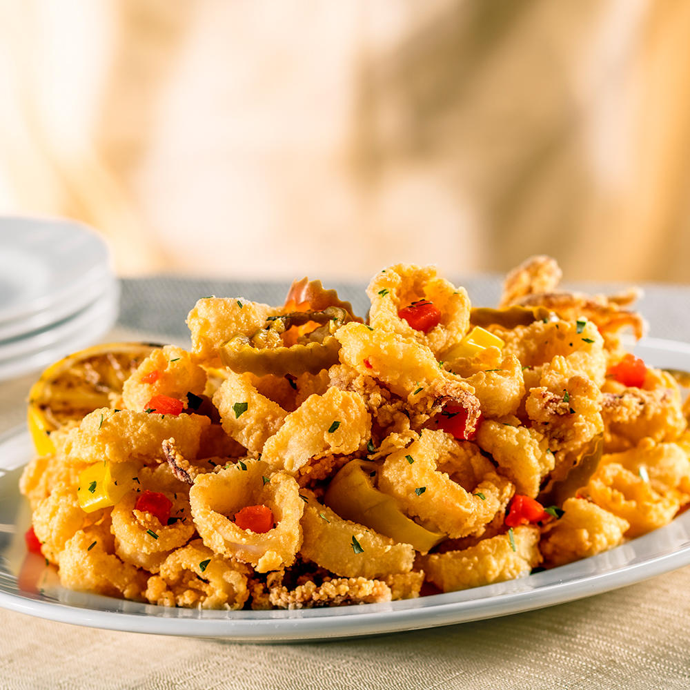 Pan-Fried Calamari with Hot Cherry Peppers. Our signature appetizer - crisp and golden with a fiery flavor.