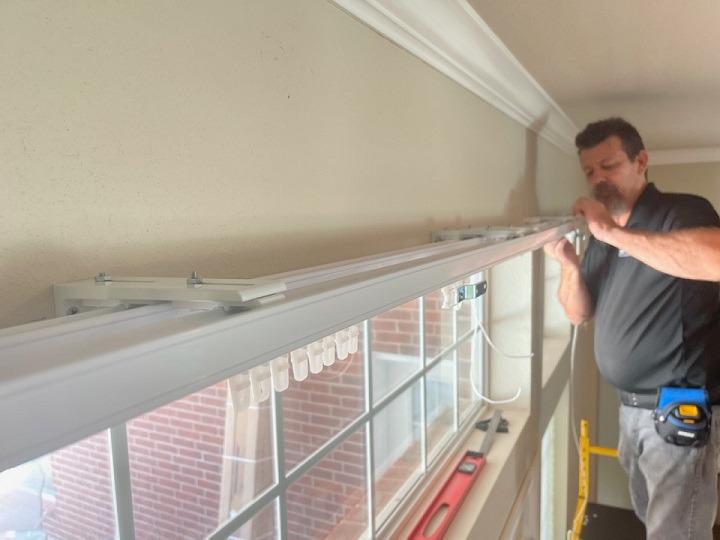 Here we are, hard at work in this Claremore home! What are we doing? Installing beautiful new Draperies-plus the rail matches the wood trim-for these homeowners!