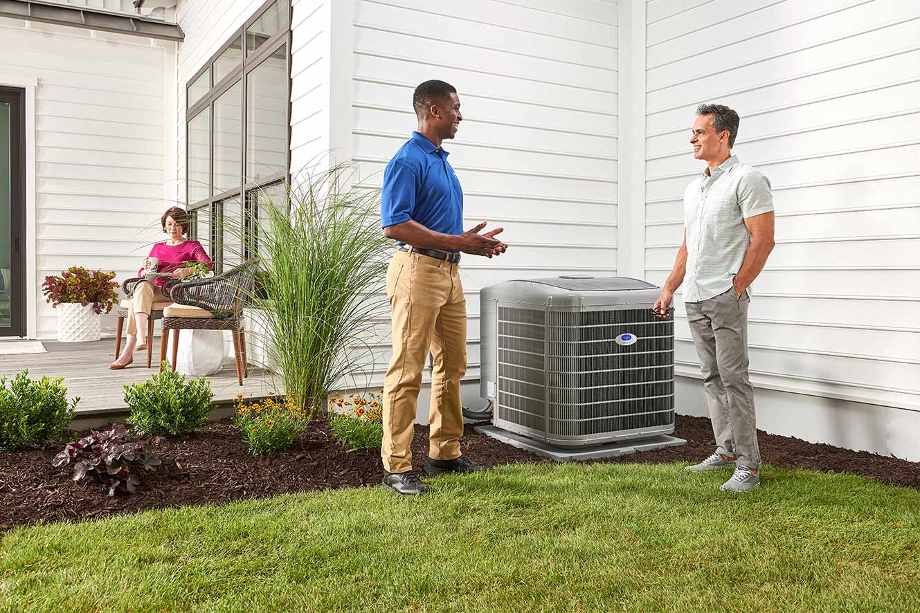 A Carrier dealer discusses AC repair and service with a homeowner