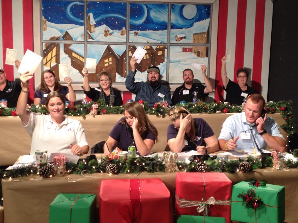 Redding Farmers Insurance volunteering at the  KIXE 2014 Holiday Auction.