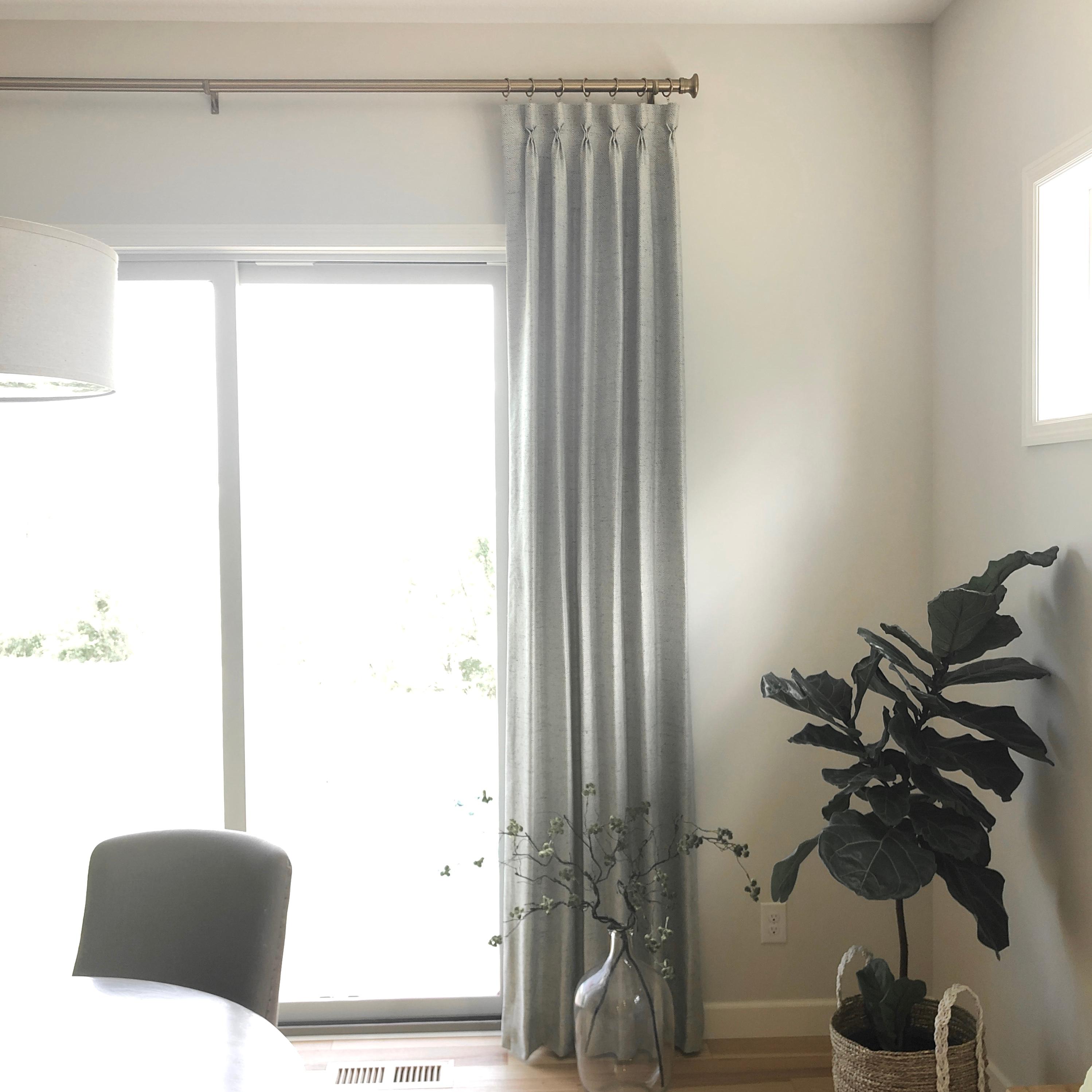 Custom drapery panels and sleek hardware will add softness and style to any space. We installed these pleated stationary panels in a home in Victoria.