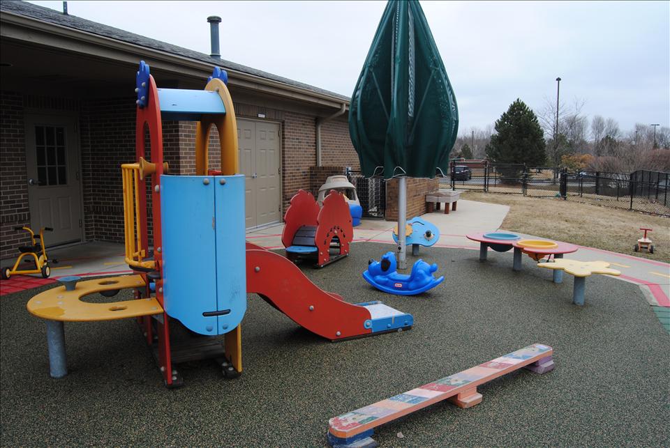 Infants, toddlers and discovery preschoolers have a large and inviting playground for outside time.