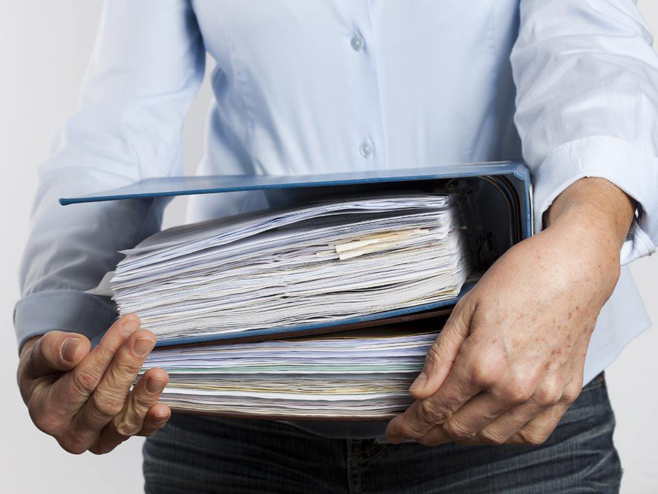 man carrying a binder of important documents to scan