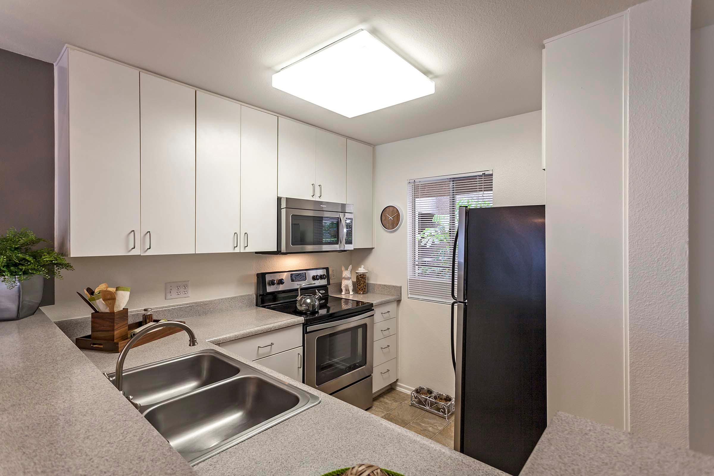 Windowed kitchen with stainless steel appliances