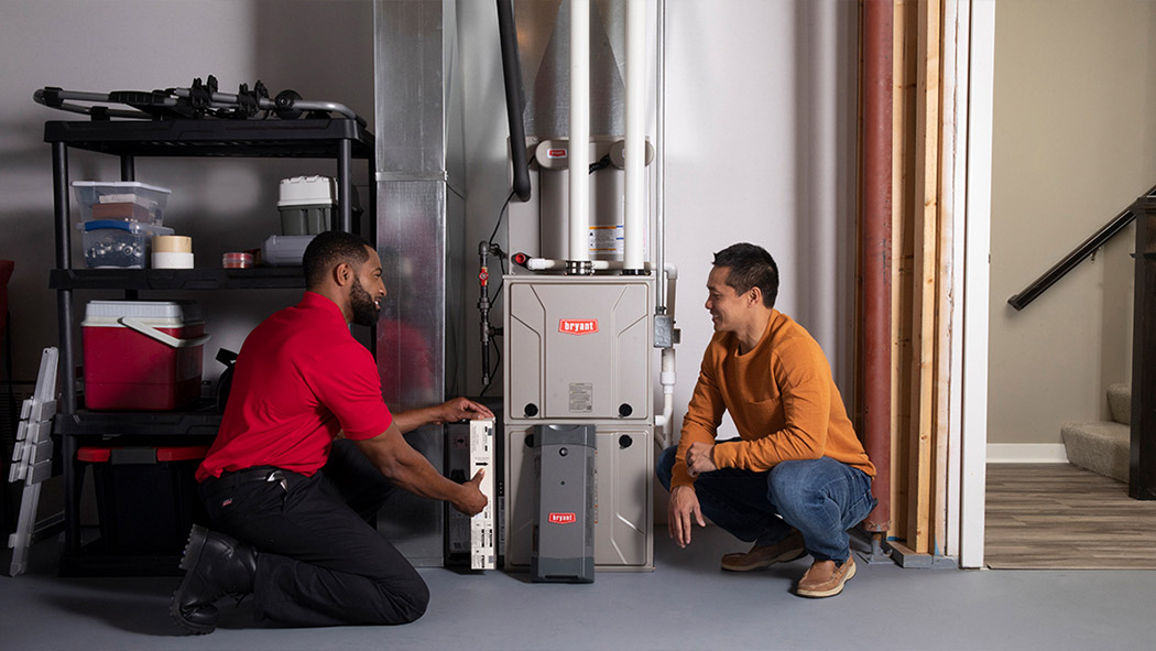 A Bryant dealer discusses furnace repair and service with a homeowner
