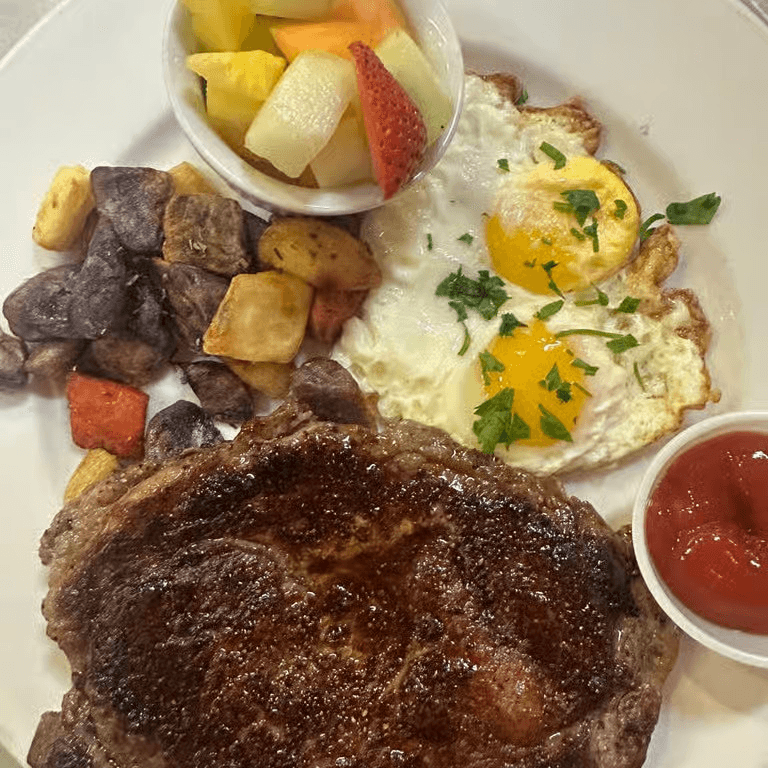 Grilled angus certified rib eye steak and eggs brunch