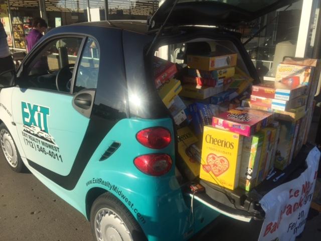 We thank everyone for being so generous and putting cereal in our car for the Le Mars Back Pack Program. Many people stopped by to visit and with cereal. You can see how full the Smart Car is!!!
