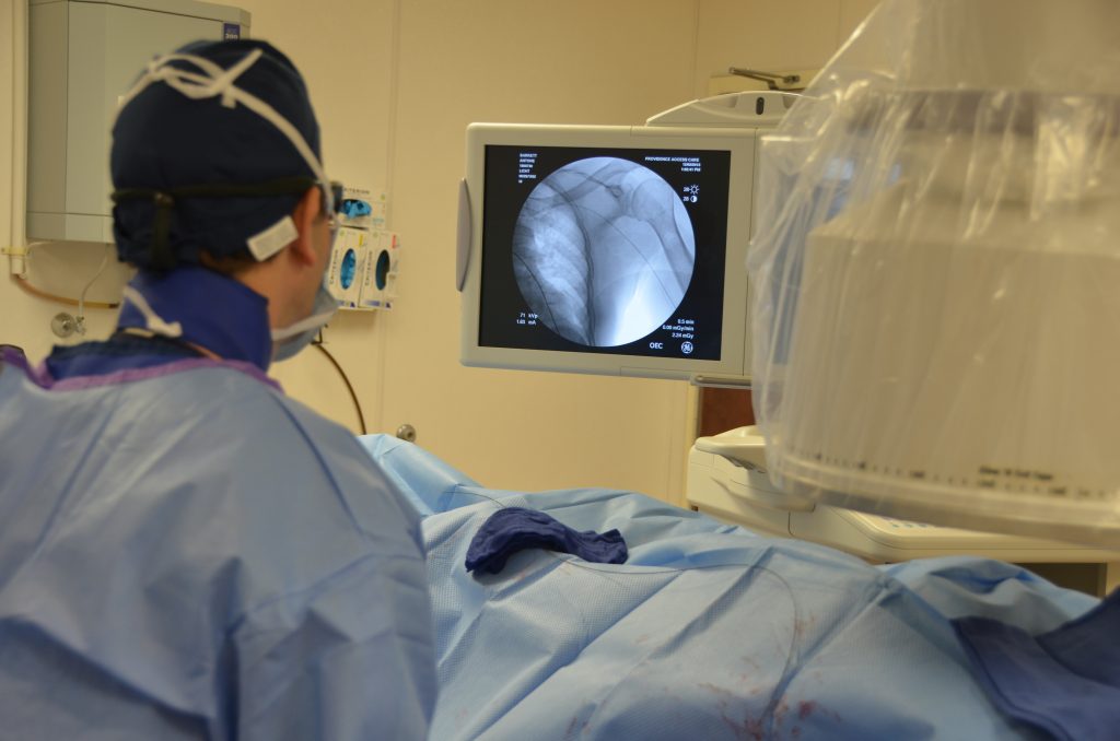A doctor and performing surgery t at Providence Access Care