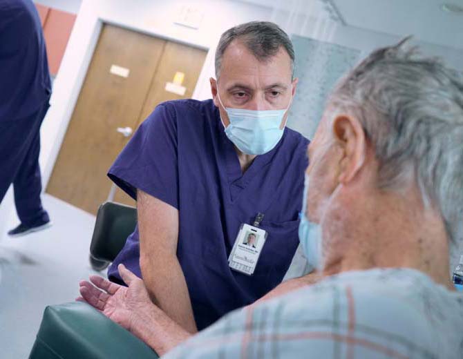 A physician at Azura Surgery Center Connecticut talking to a patient