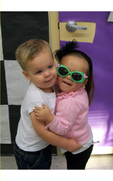 A Toddler and Two-year-old are celebrating the 50th day of school with a 50's style sock hop!