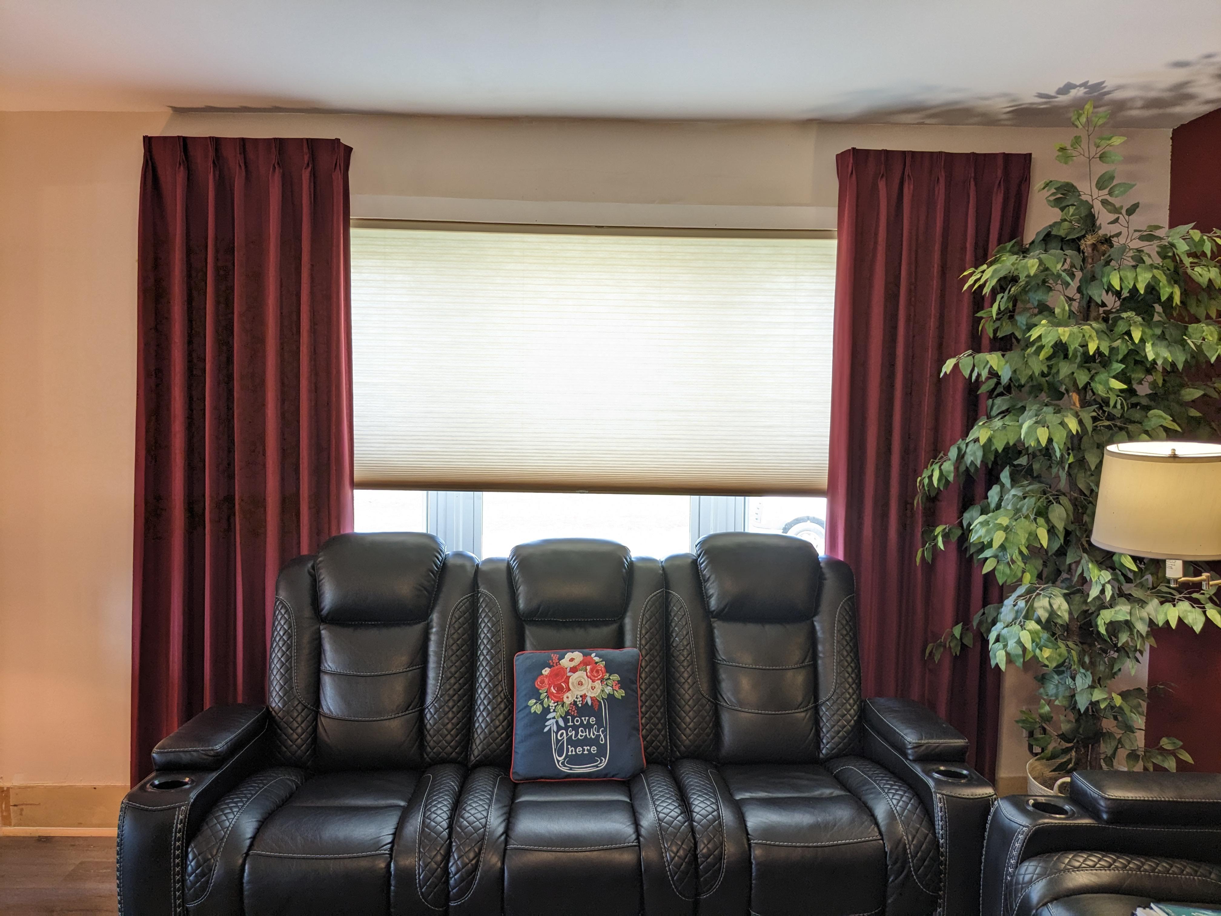 Light filtering cordless cellular shade with stationary side panel drapery in Springfield Illinois living room.  BudgetBlinds  WindowCoverings  Shades  Drapery