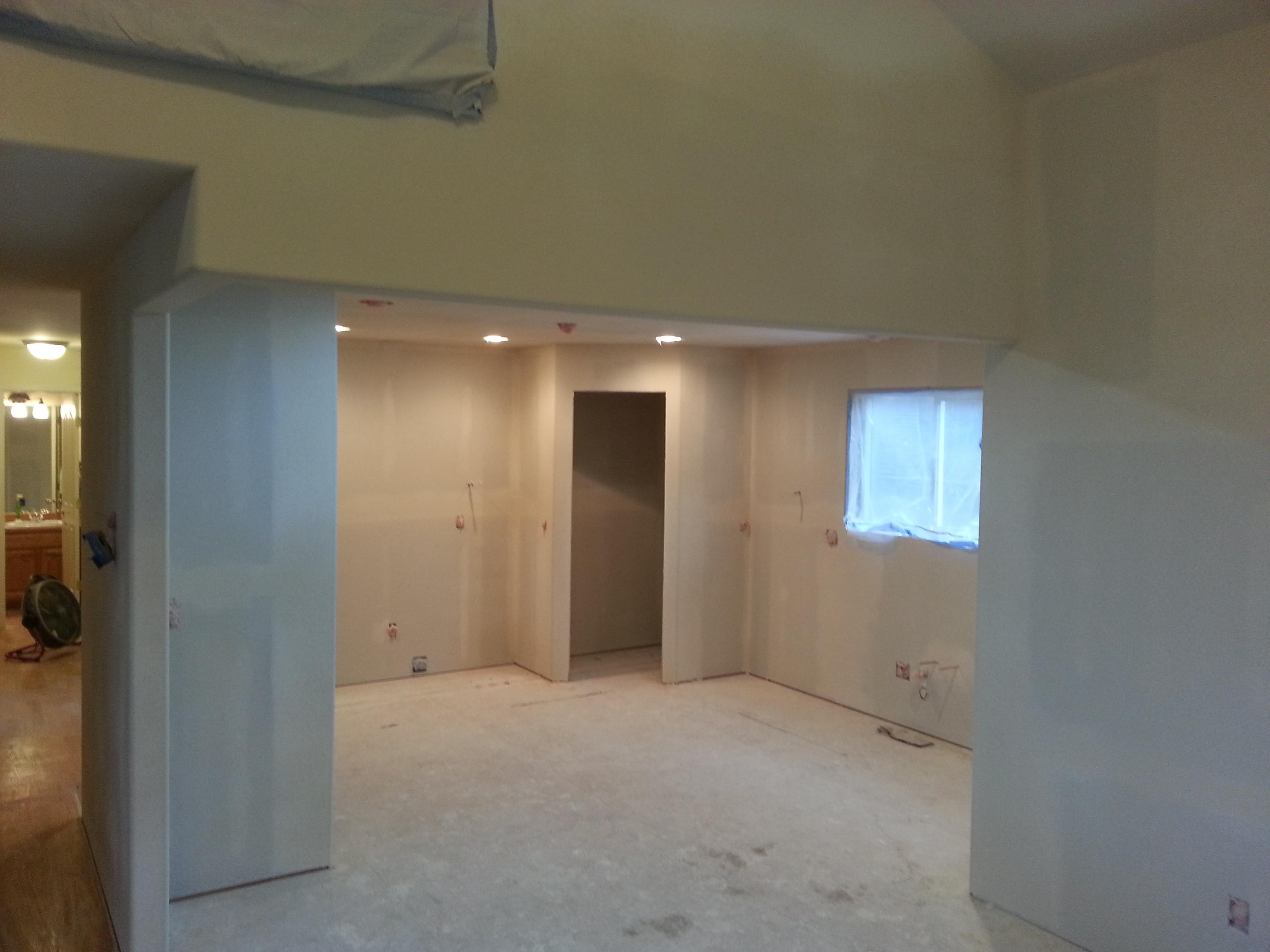 Opening a small closed kitchen into a more open plan with a pantry and an island. We took the project to drywall texture, home owner will be painting.