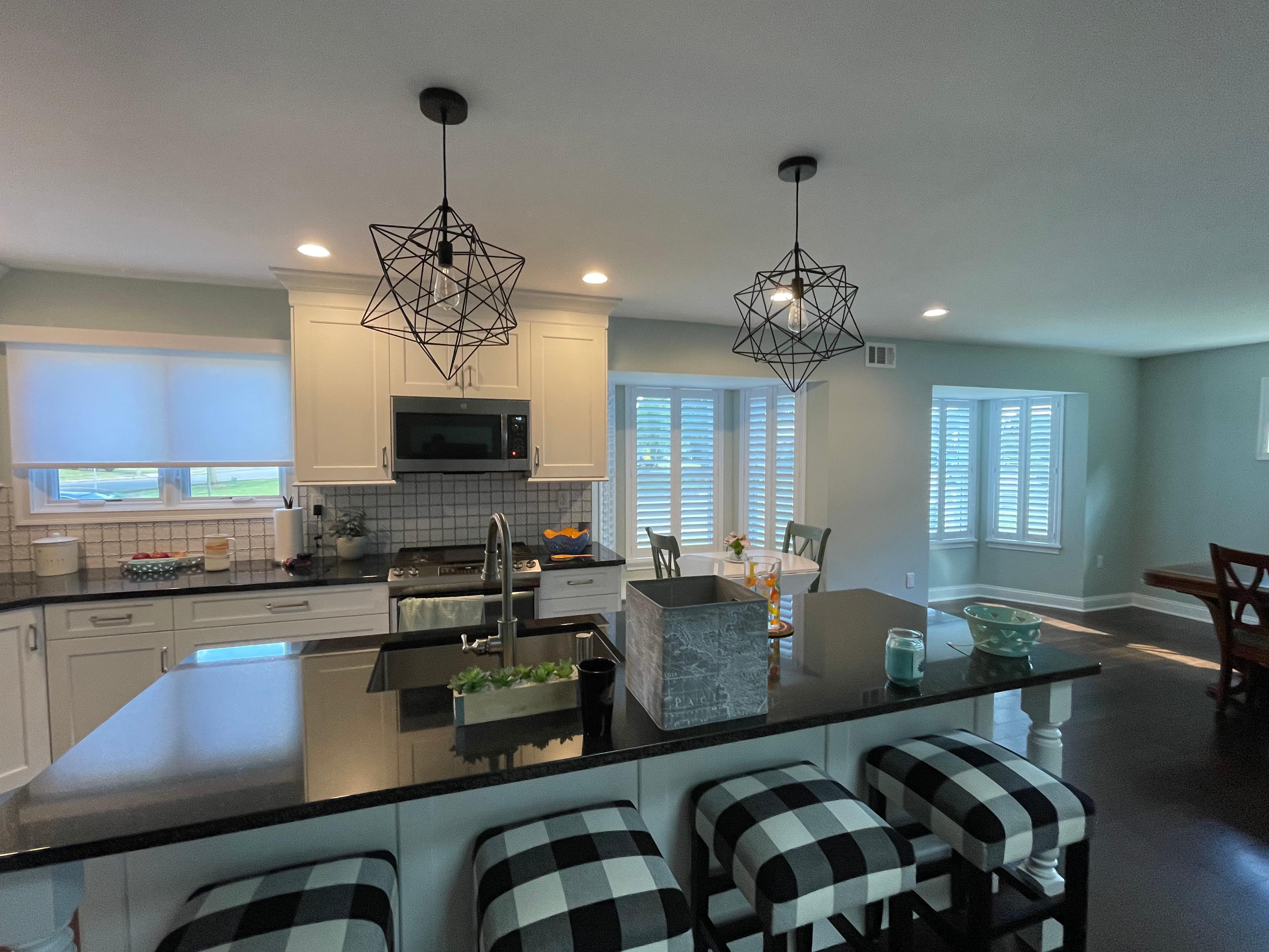 Shutters on bay windows and roller shades in kitchen!