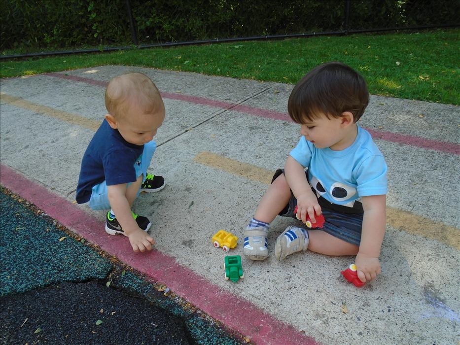 Toddlers are learning how to share, take turns, and have conversations. Here is Alex and Tyler playing with cars during outdoor play. Boy, were they trying to talk!