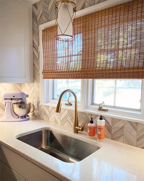 Kitchens are typically dominated by hard, straight surfaces. Bamboo shades can add organic softness for a warmer feel.