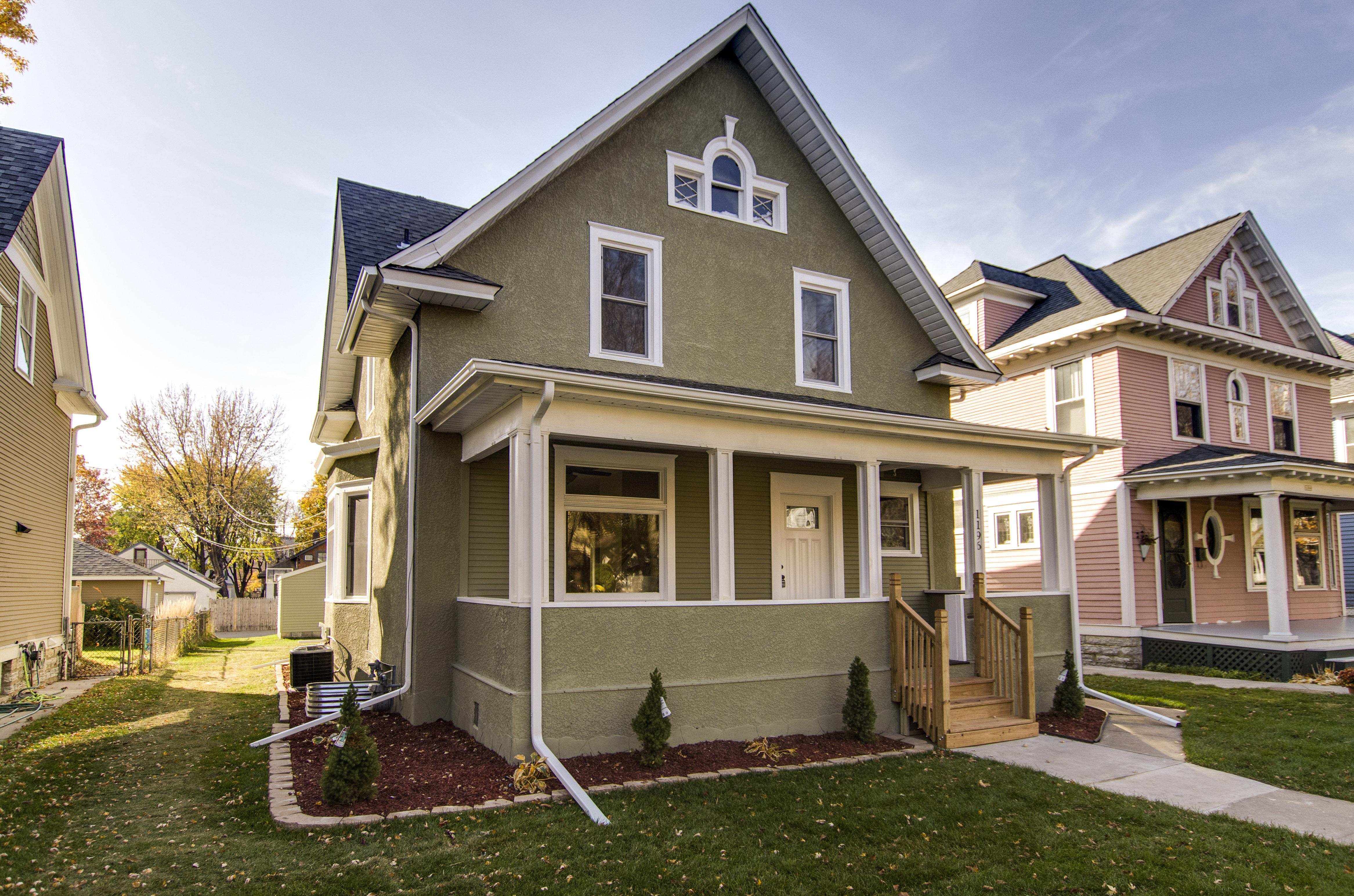 What a difference paint and opening the front porch can make to bringing back the traditional look of a home