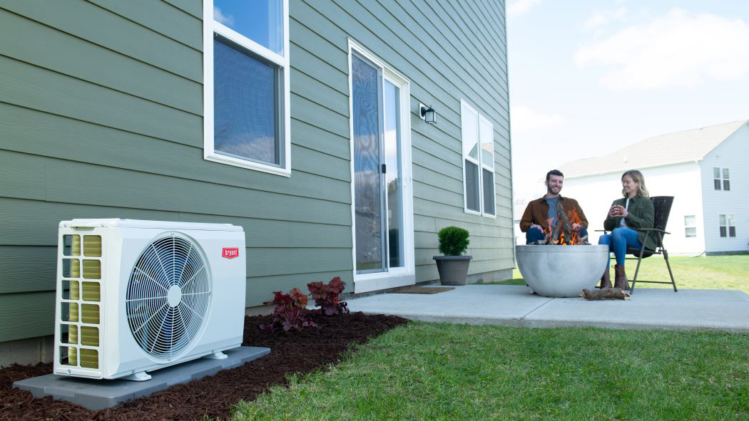 A couple relaxes in backyard after mini split installation