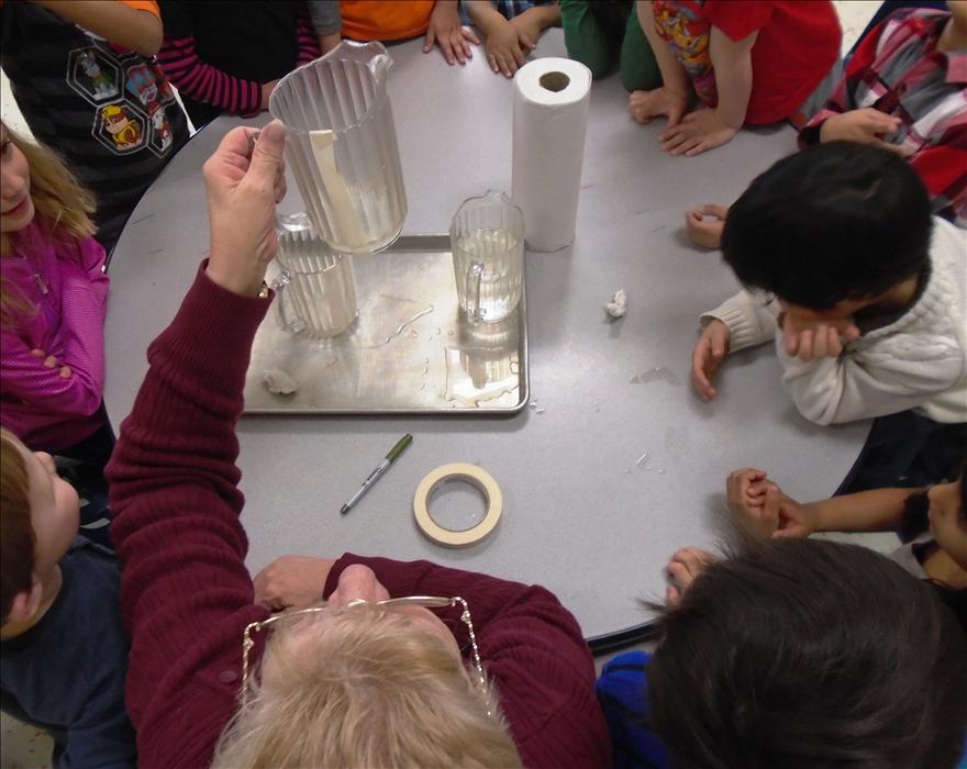 Ms. Karen conducting a science experiement on absorption of water for our Learning Adventures program