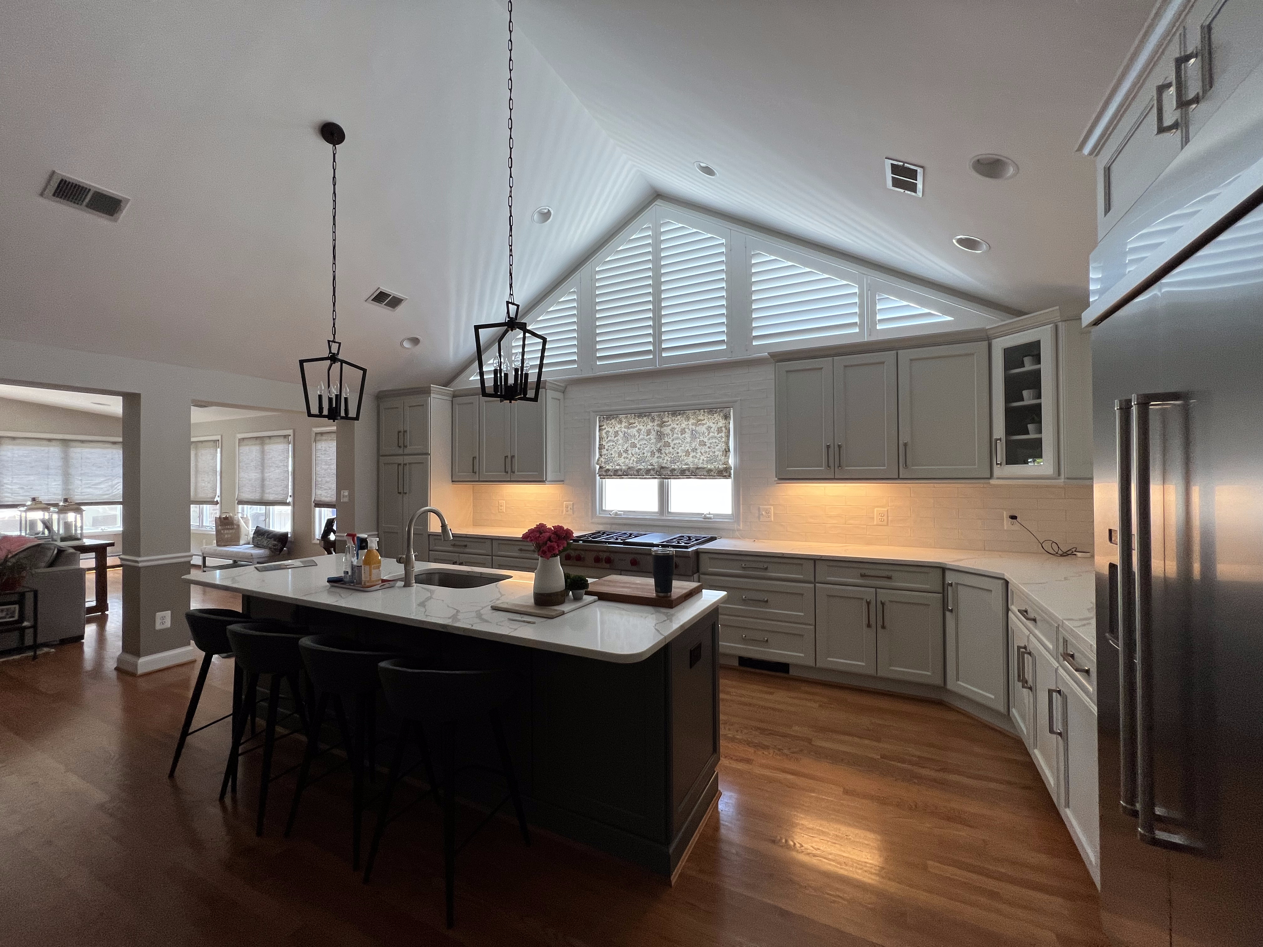 This Arlington kitchen has amazing windows above the cabinets! You can't put curtains on them. Our solution? Kitchen Shutters! Check out the before and after!