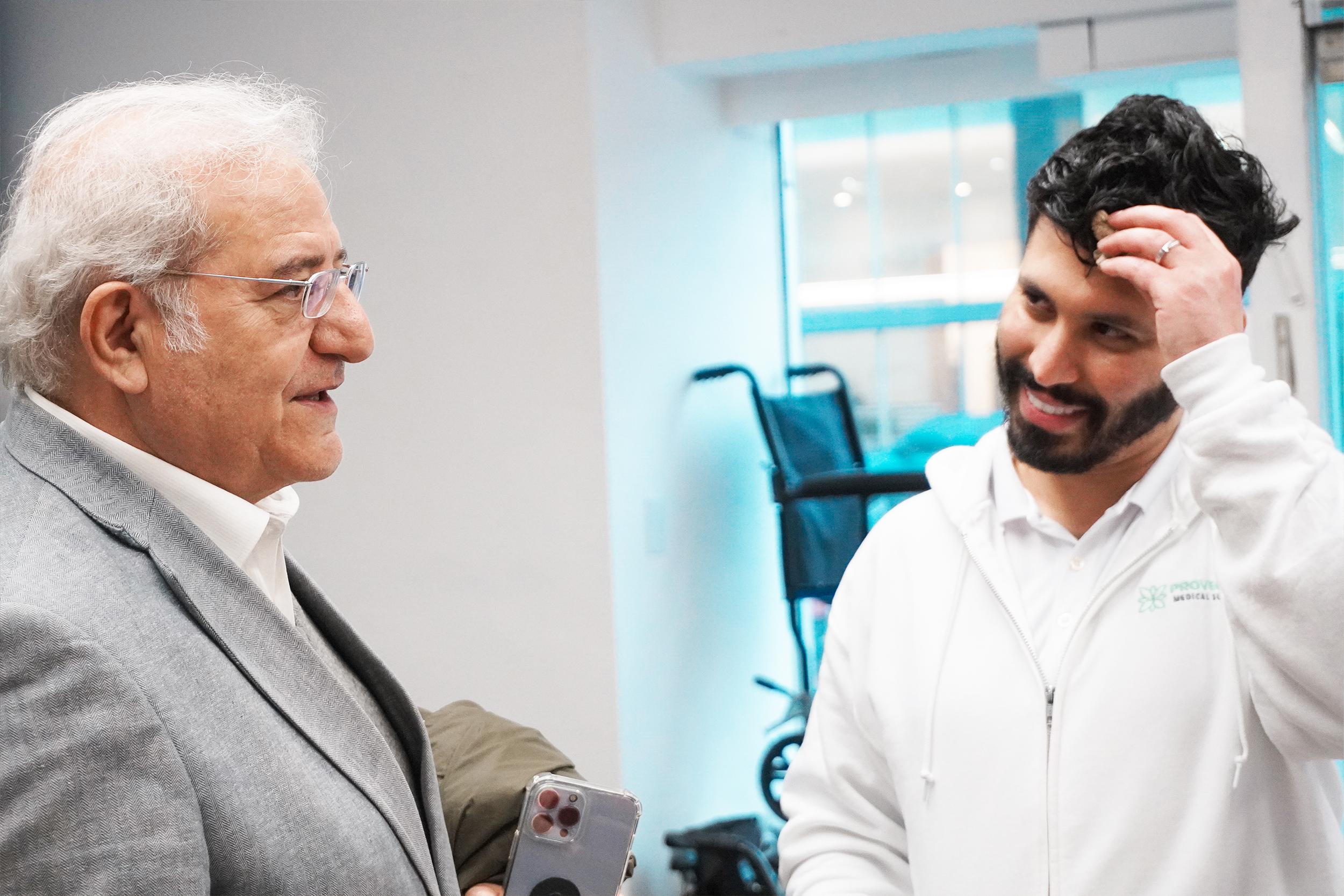 senior customer talking to medical store owner