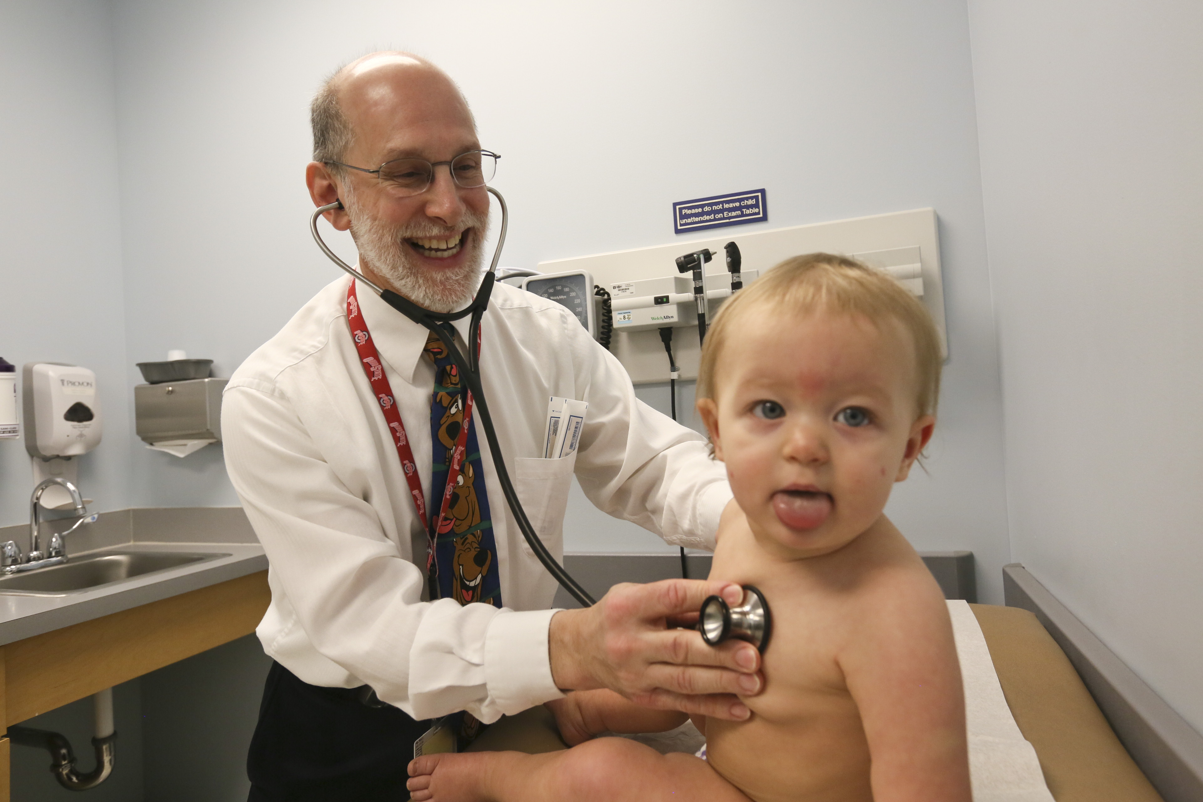 Dr. Michael DeLucia, Jr., performs a well-child check on a baby in the Akron Children's Hospital Pediatrics office in Ellet.