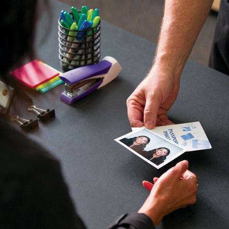 The UPS Store franchisee handing passport photo to customer