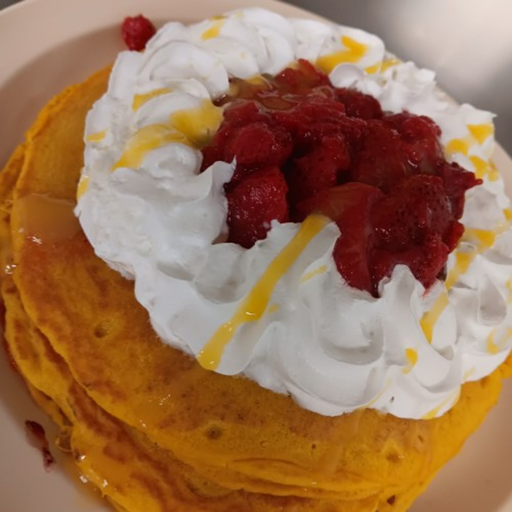 Two Hot Cakes with Strawberries and Whipped Cream
